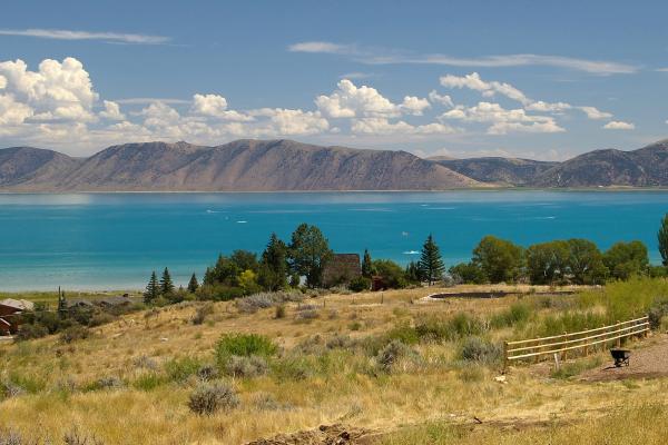 Turquoise water of Bear Lake below the hills of the Utah shore